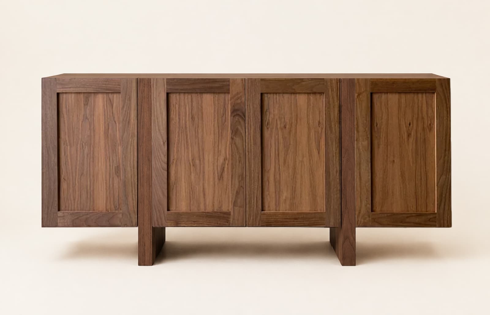 The finished four-door walnut credenza from the drawing in step one, photographed straight on against a soft cream background